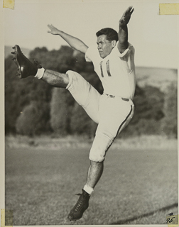 Herman John Wedemeyer kicking a football, 1947