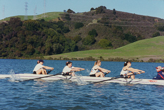 Four women from the crew team rowing at Briones Resevoir, 1990