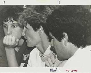 Coach Terri Rubenstein in the center of a women&#39;s basketball team huddle, 1995