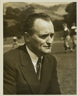 Edward P. &quot;Slip&quot; Madigan kneeling on a football field, 1937