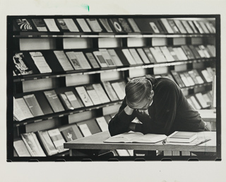 Student reading inside the Saint Albert Hall Library, 1969