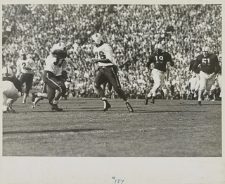 Herman John Wedemeyer running with the ball during a football game, 1947