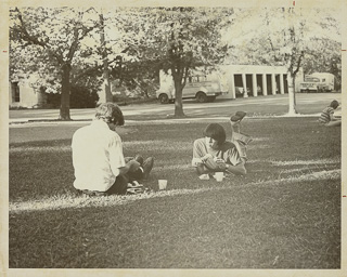 Students sitting on a campus lawn, 1980