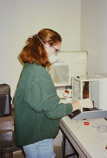 Student working in a science lab, undated