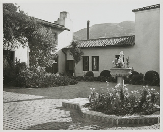 Students&#39; patio with a view of the fountain used as a flower planter, undated