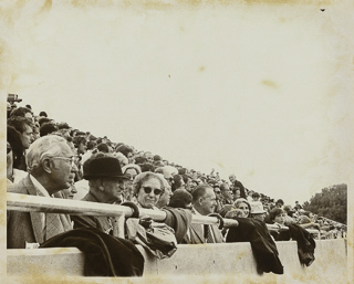 Judge Louie Freitas and Fred Ferroggiaro sitting in the crowd at a football game, 1975