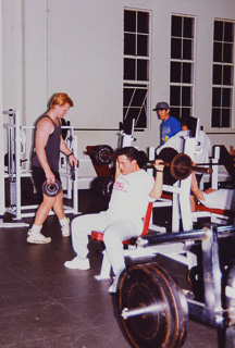 Students lifting weights in the gym, 1999