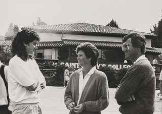 Coach Terri Rubenstein in the center of a women&#39;s basketball team huddle, 1990