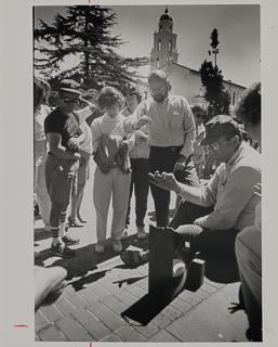 Brother Raphael (in cap) showing how to make a pinhole image of the sun using thumb and forefinger during the solar eclipse, July 1999