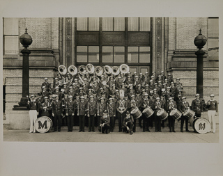 Saint Mary&#39;s College Band posing in front of San Francisco Polytechnic High School, 1933