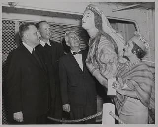 Brother Xavier, Brother Timothy, Phil Baker, and Mrs. Baker at a wine tasting party aboard the Balaclutha ship in San Francisco, May 1961