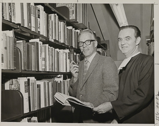 Library Director William Macaskill (left) and Brother Matthew Benney (right) in the library, 1970