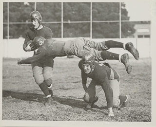 Members of the football team practice a flying tackle at the Oakland campus, 1915