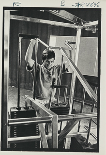 Student using a weight lifting machine, 1975