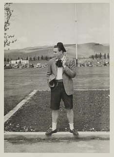 Young man standing in the chapel quad, 1940s