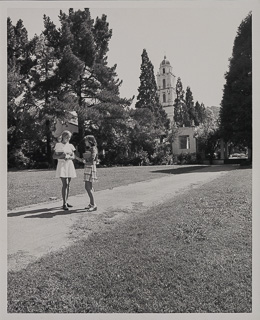 Two female students near Poplar Grove with the chapel tower in background, 1970